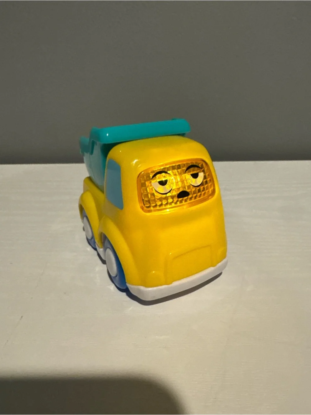 Yellow & Teal Kids Dump Truck Toy - Cute Face Design. Lights up and makes sounds